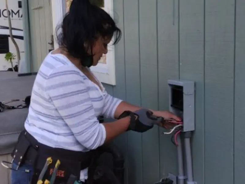 Licensed electrician wiring an exterior subpanel in Blair